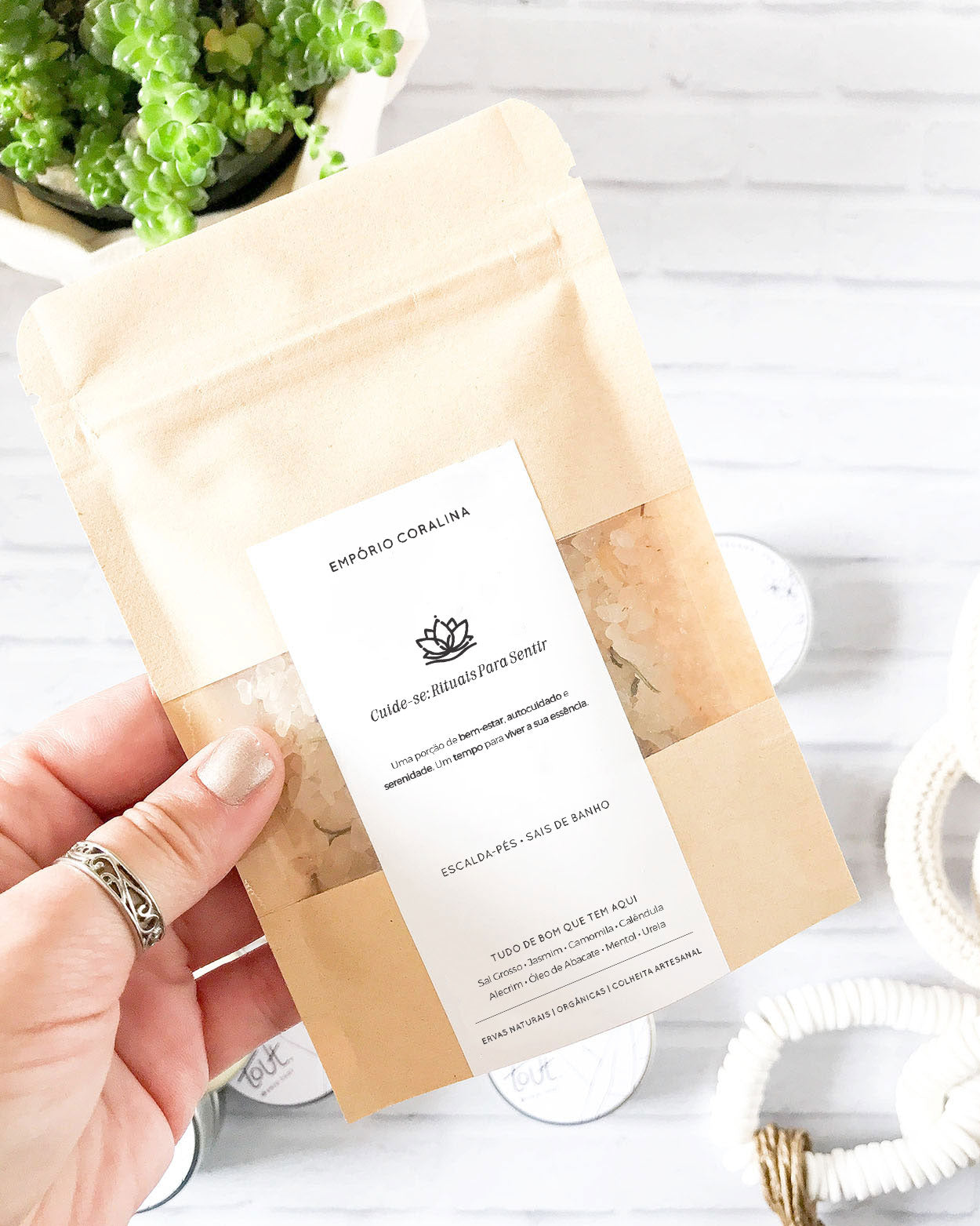 Envelope sachê kraft com visor transparente e etiqueta personalizada, fechamento tipo zip lock, com escalda-pés e sais de banho, para rituais de bem-estar e autocuidado. Com a frase: Cuide-se: Rituais Para Sentir / Uma porção de bem-estar, autocuidado e serenidade. Um tempo para viver a sua própria essência.